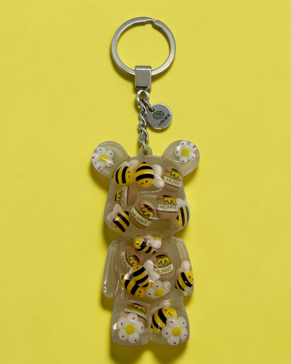 Bee Lovely, porte-clés ours en résine époxy fait main décoré de mini abeilles et de petits pots de miel.