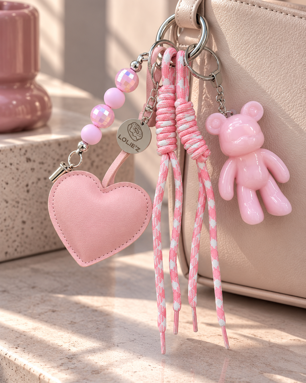 Grigri de sac Lolie’z rose avec Teddy’z en résine époxy, grand cœur rose, perles et cordons rose et blanc, création assemblée à la main en France.