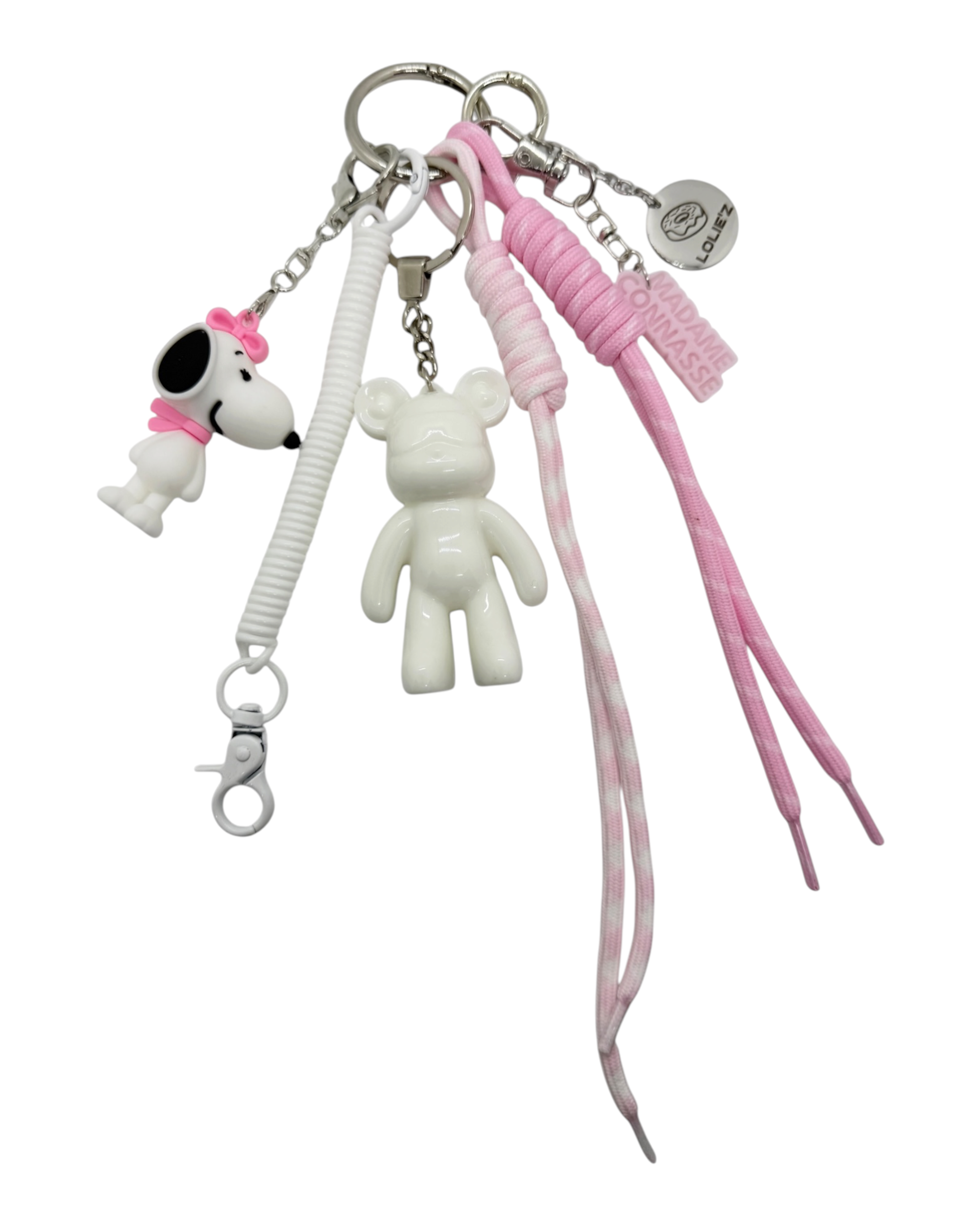 Grigri Pretty in Pink avec Teddy’z blanc glossy en résine époxy, petit chien au nœud rose, cordons rose tendre et blanc et accessoires assortis.
