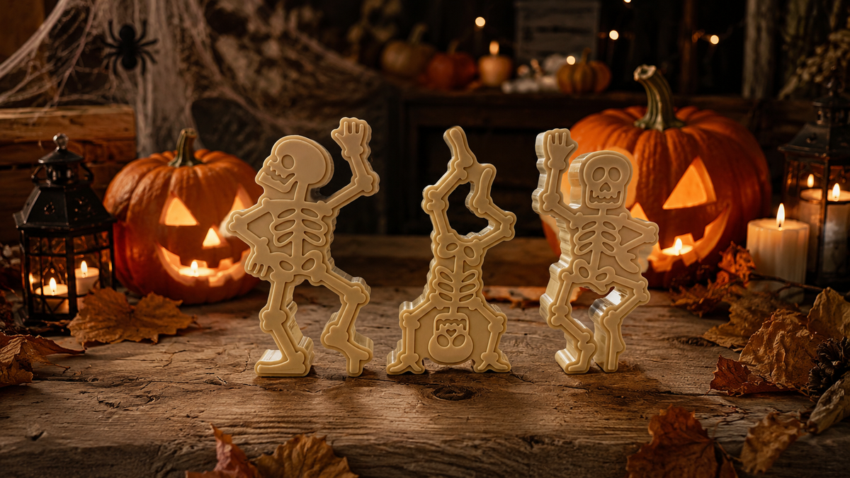 Trio de squelettes décoratifs en résine Lolie’z dans une ambiance Halloween avec citrouilles illuminées et décor automnal.