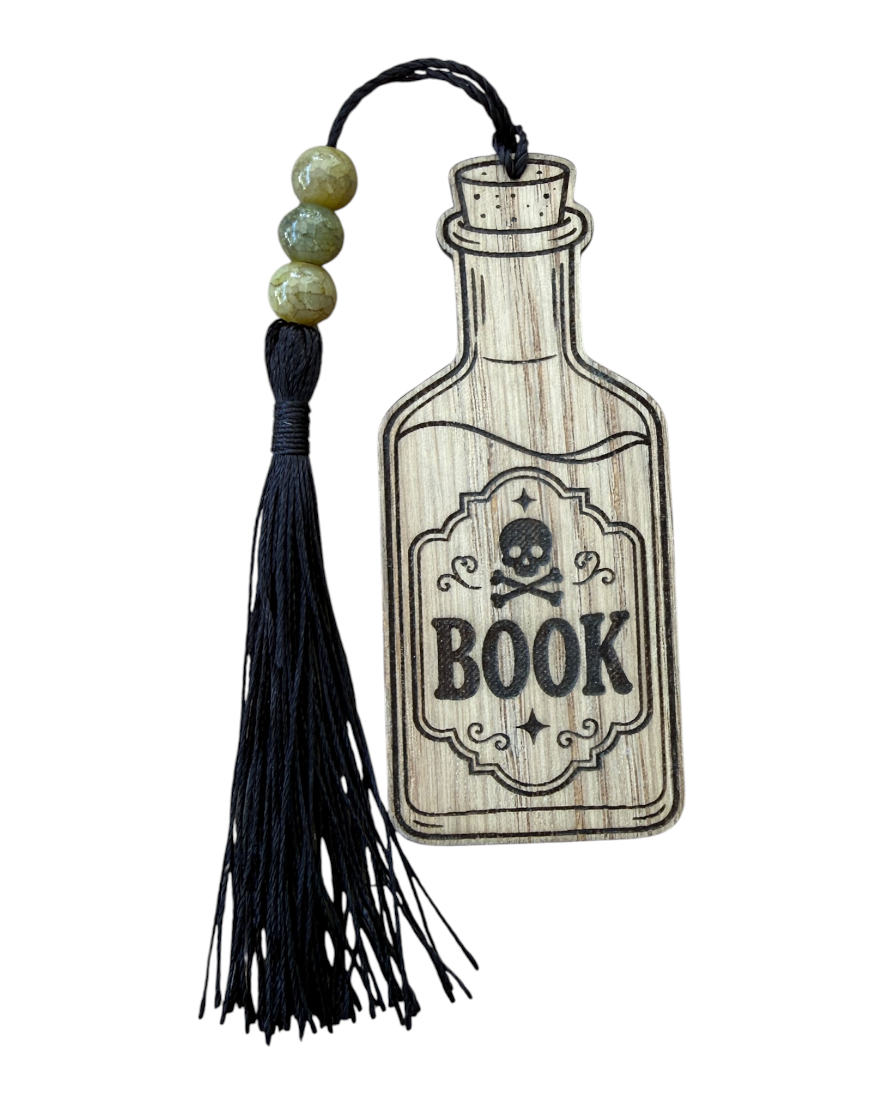 Bookmark Elixir en bois gravé Lolie’z représentant un flacon avec inscription BOOK et tête de mort, terminé à la main avec perles et pompon noir.