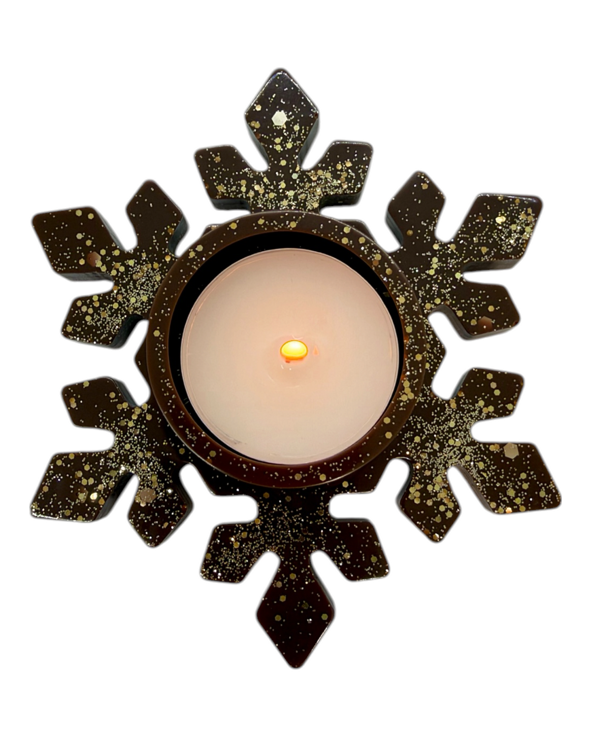Bougeoir Floky en résine époxy chocolat parsemée de paillettes dorées, en forme de flocon de neige aux branches géométriques, avec bougie chauffe-plat LED au centre, photographié sur fond blanc.