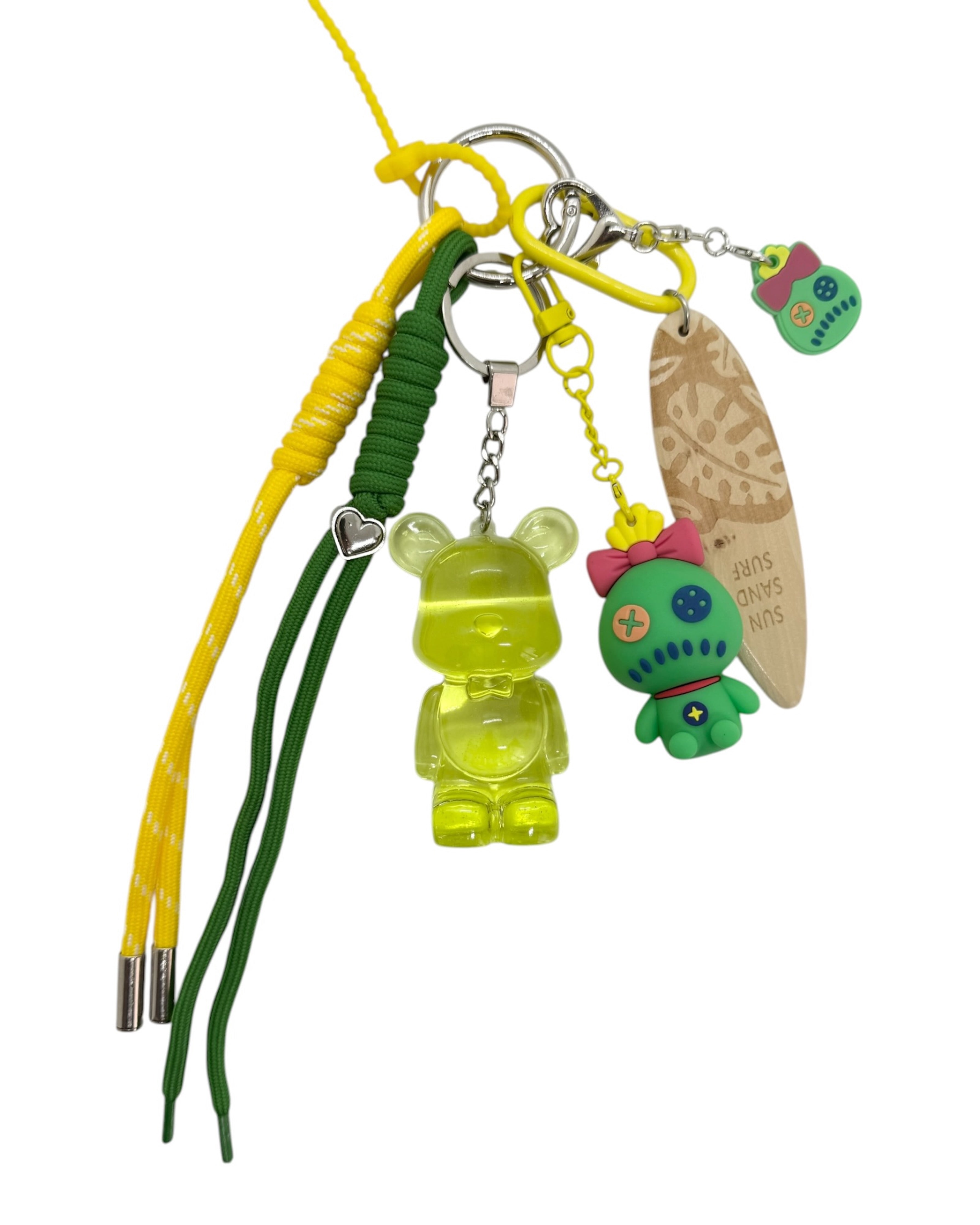 Porte-clé Teddy’z vert translucide avec détails jaunes et charms inspirés d’un univers tropical
