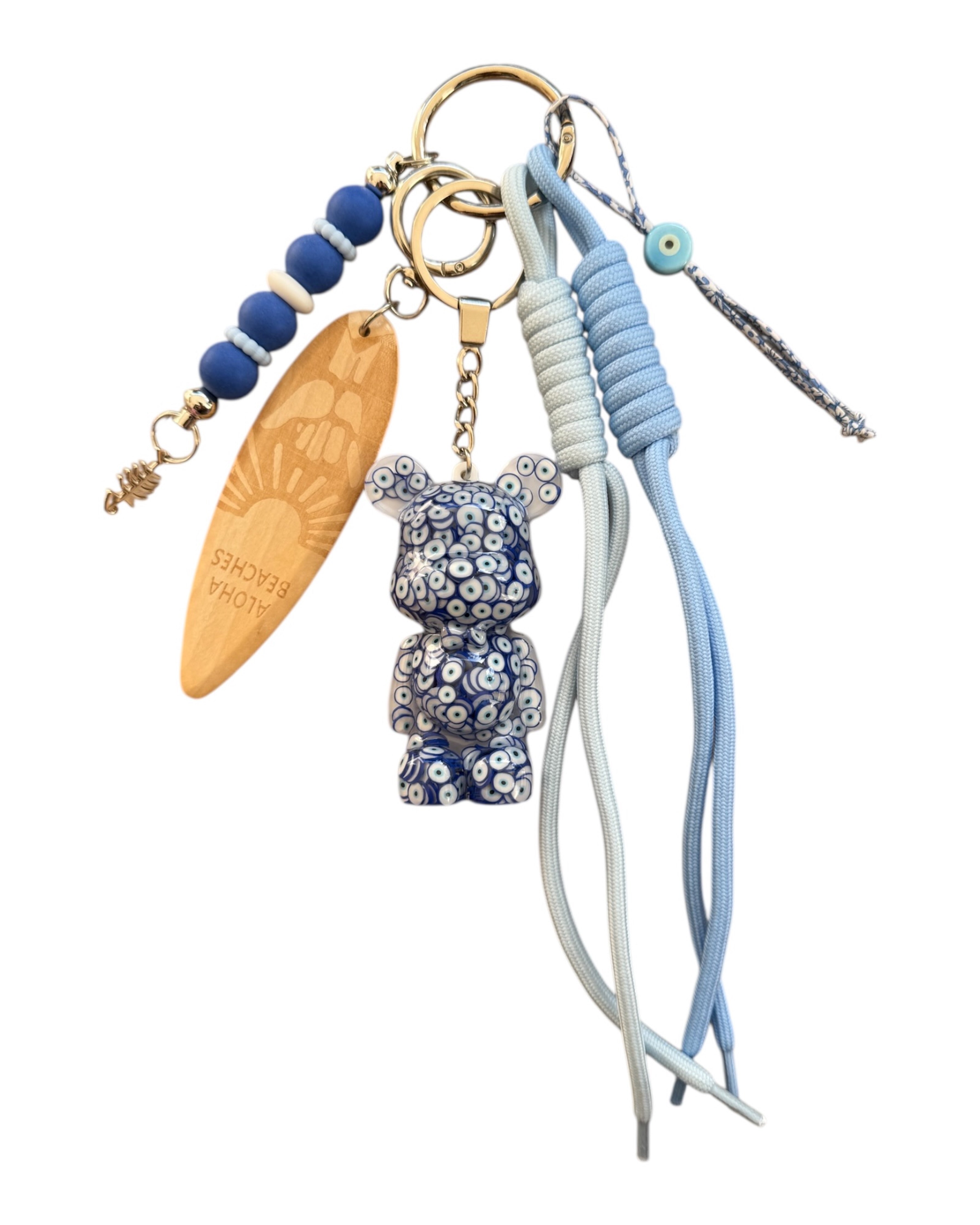 grigri Porte-clés Teddy’z Blue Nazar en résine époxy avec motif yeux bleus et cordons bleu clair
